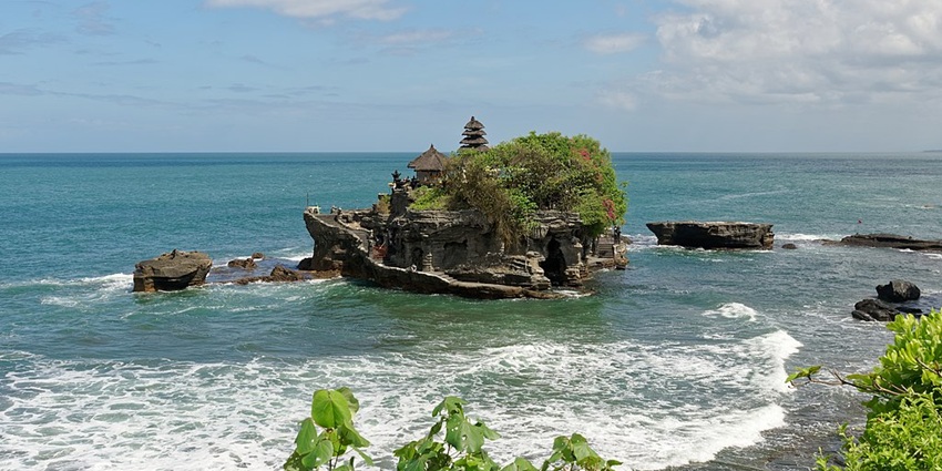 Image of Tanah Lot Temple at high tide, Bali, Indonesia surrounded by body of water