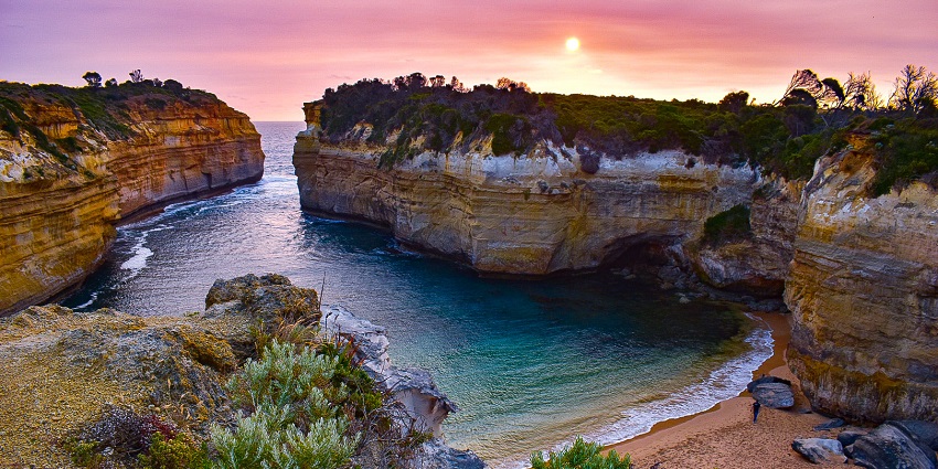 A beautiful sunset over the Great Ocean Road, highlighting the rugged coastline.