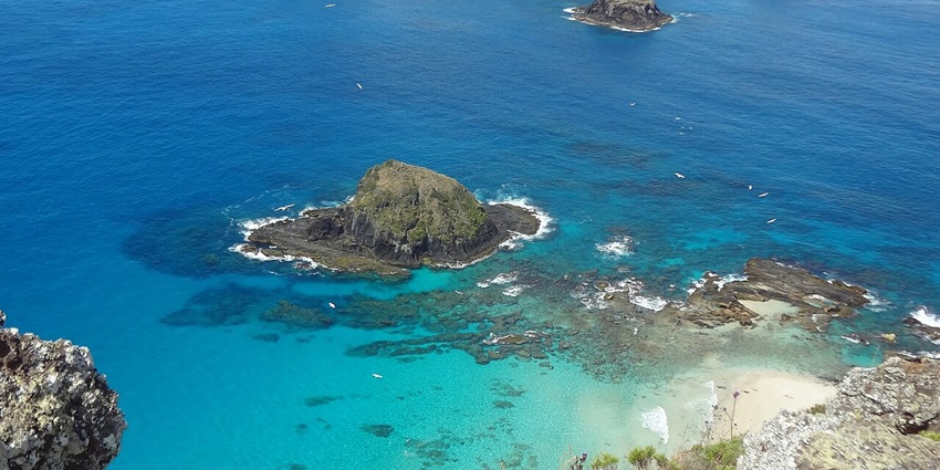 Aerial view of the Lord Howe Island, with a piece of land surrounded by crystal clear waters