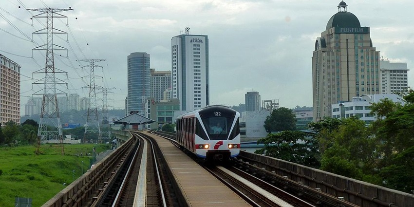 An image of an urban train on elevated tracks in Petaling Jaya with many buildings visible under clouds