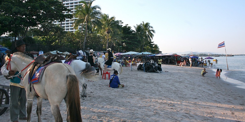 Hua Hin Beach in Thailand with a sandy shore and ocean waves in the background.