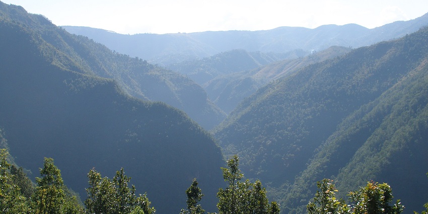 A scenic view of Palpa Valley, Nepal, surrounded by lush green hills and traditional houses