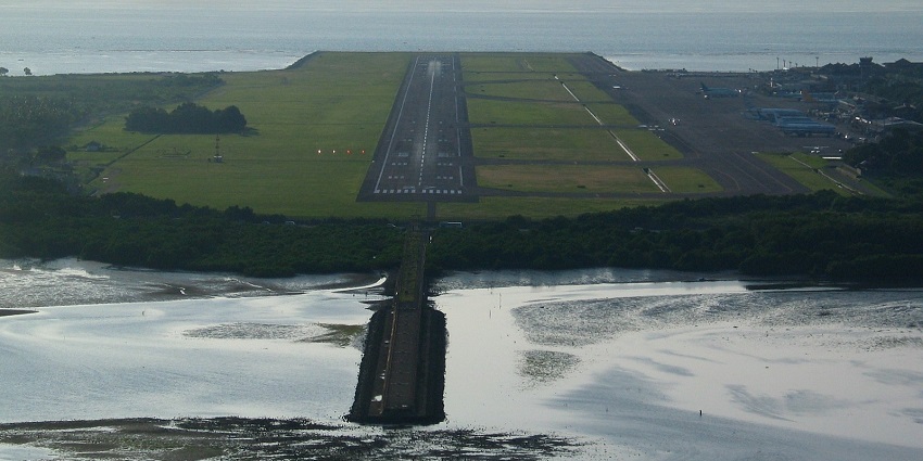 Denpasar International Airport has a modern terminal, Balinese architecture, and runway.