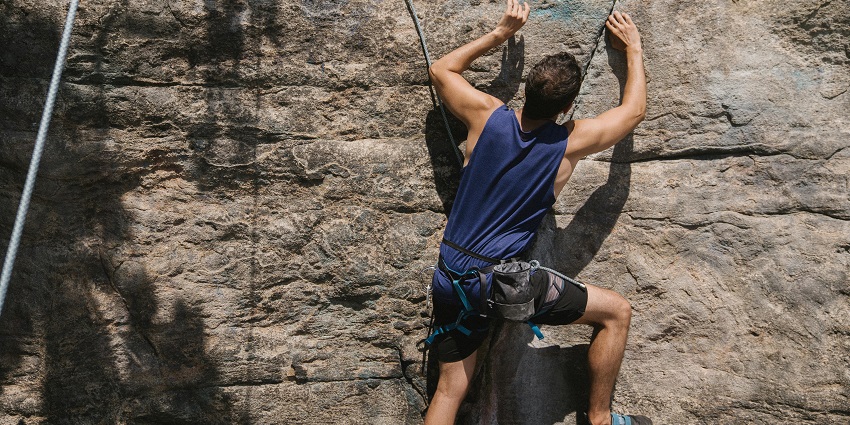 Image of a tourist starting his rock climbing adventure