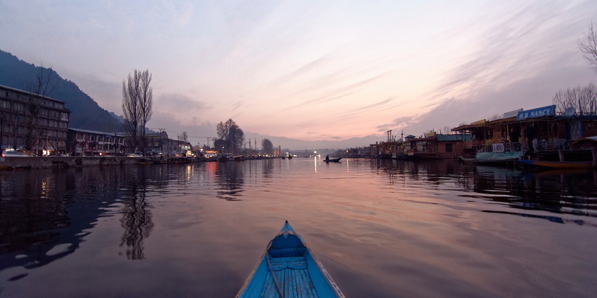 A scenic view of Dal Lake covered in a soft winter glow