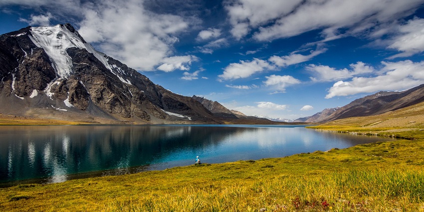 Karambar, deepest lake in Pakistan, with a large water body, green shoreline, snowy mountain