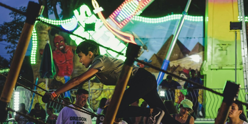 An image of a boy enjoying a ride in OxyZone adventure park at night.