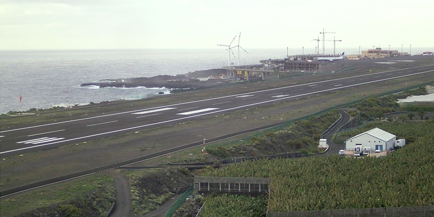 A splendid runway beside the magnificent sea with the beautiful windmills in the background.