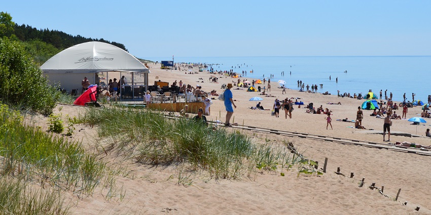 Scenic view of Palanga Beach with sandy shorelines and people enjoying the seaside