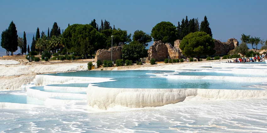 Pamukkale is famous for its white travertine terraces and thermal hot springs.