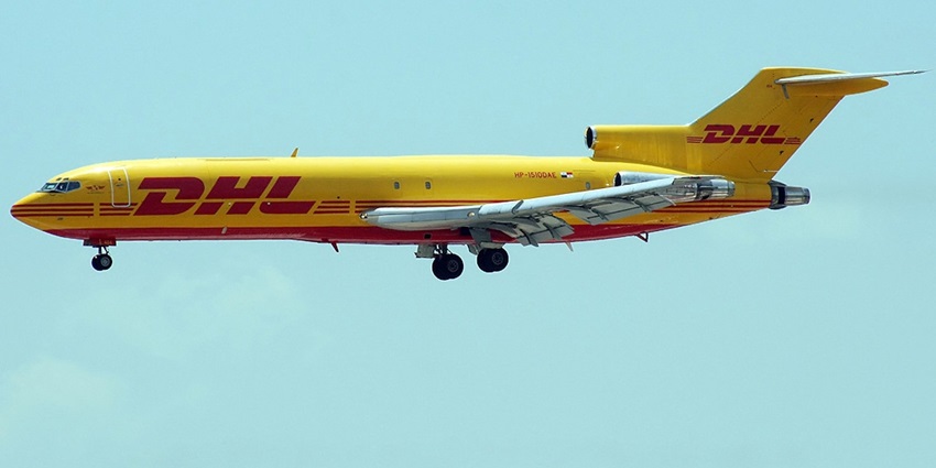 DHL Aero Expreso aircraft in bright yellow livery soaring through a clear blue sky