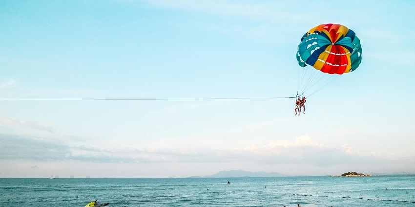 An image of a parasail with two people, one of the water sports in Agonda Beach.