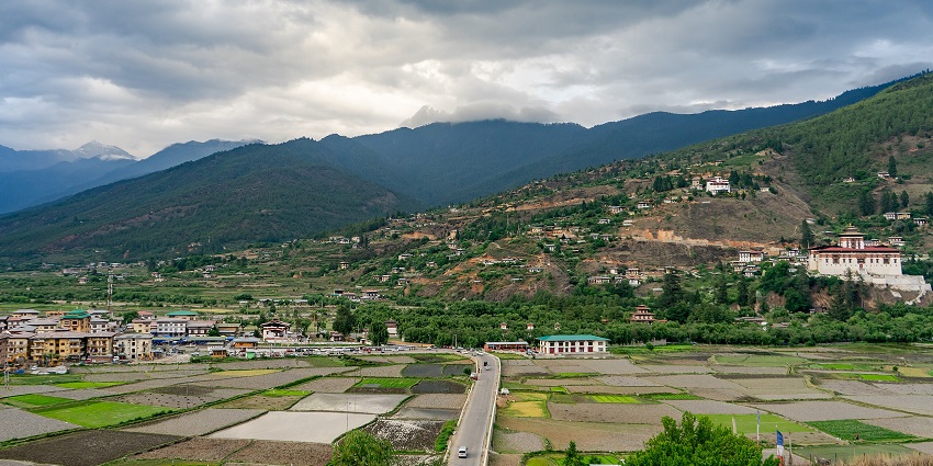 Near the Paro River, enjoy the view of Tiger's Nest Monastery on a rocky cliff.