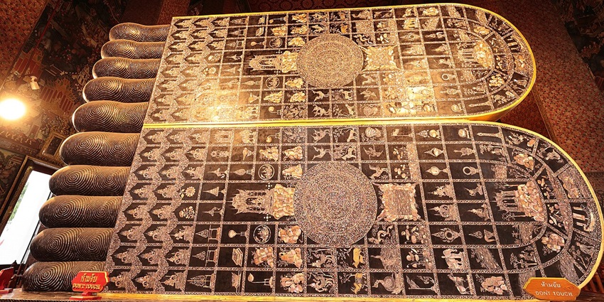 Visitors drop coins at Wat Pho Temple, symbolising almsgiving and connecting with traditions.