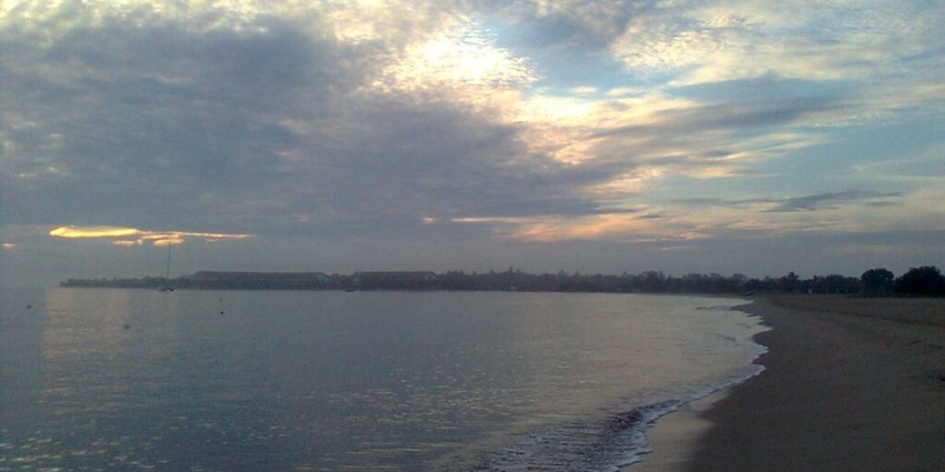 Beautiful beachside at Pasikudah, featuring the sun hues reflecting on the waves