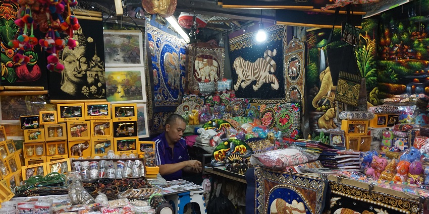 Busy street scene of Patpong Night Market with the stalls and vendors of street foods.