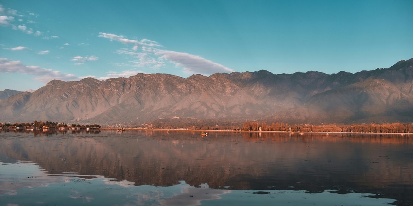 Alpine lake in Kulgam, Kashmir nestled below Brahm Sakli Peak, offering pristine views and challenging trekking experiences.