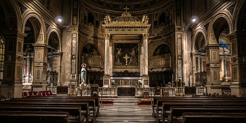 An image showing a woman reading Bible passages with her hands on a book during Pentecost.