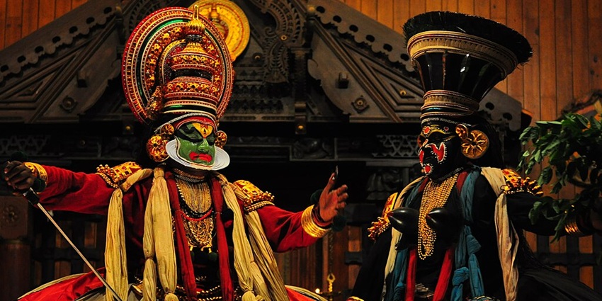 A Theyyam performer in full costume and makeup, most fascinating Indian festivals in December