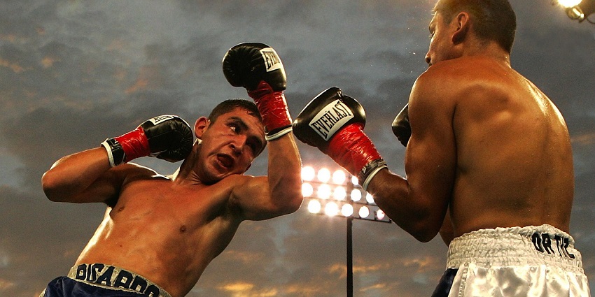 An image of a boxing match in a sports venue similar to Petch Buncha Boxing Stadium.