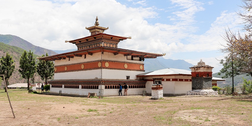 Image of a monastery in Bhutan surrounded by stunning hills and landscape view during day time