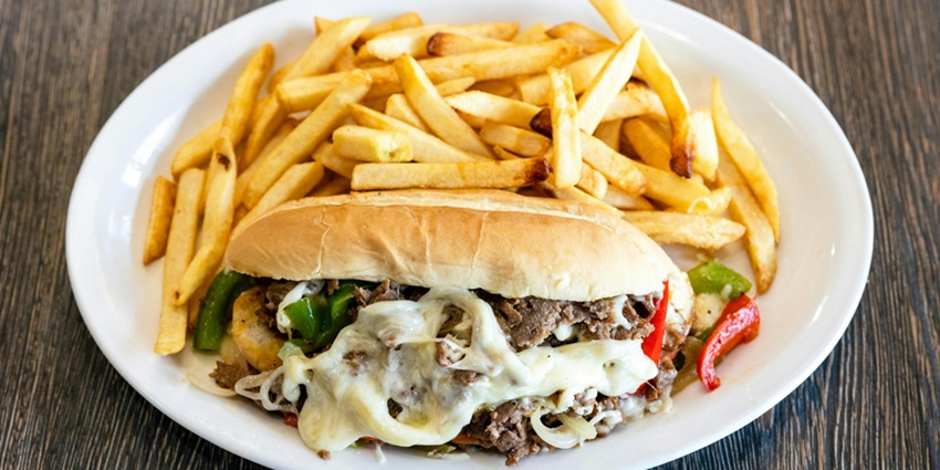 An image of a Philly cheesesteak sandwich filled with beef, a famous food in the USA.