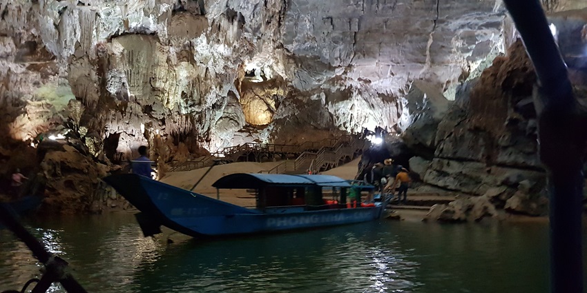 An image of Phong Nha cave in Vietnam, showcasing its stunning rock formations and river entrance.