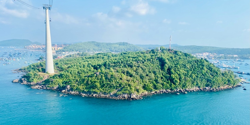 An aerial view of the scenic Phu Quoc Island surrounded by lush green vegetation.