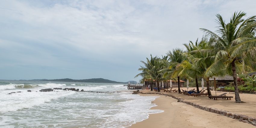 An image showing a beach on Phu Quoc Island, Vietnam, with sandy shores and clear waters.