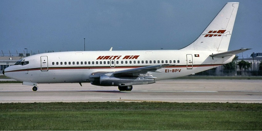 Haiti Air Boeing preparing for takeoff with lush green fields stretching in the foreground