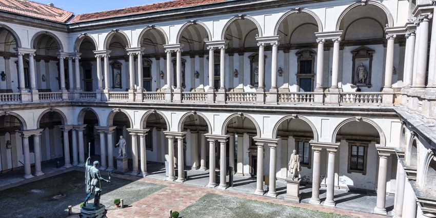 The iconic structure with a statue in the courtyard of Pinacoteca di Brera, one of the places to visit in Milan.