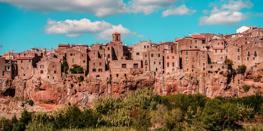 Stunning view of the ancient houses under the clear sky and snow-white clouds.