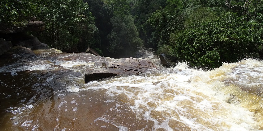 An image showing Popokvil Waterfall at Bokor Hill Station, with cascading water over rocks.