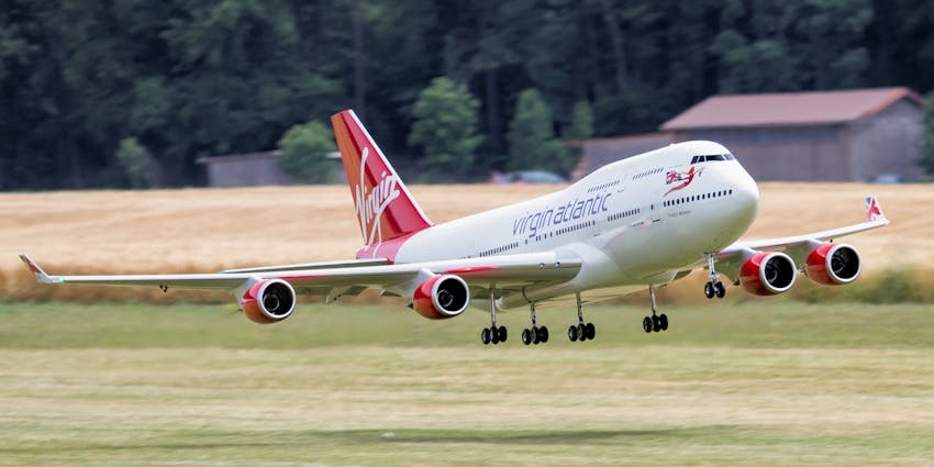 A passenger aeroplane taking off from a grass runway, at one of the airports in Benin.