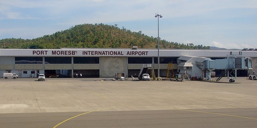 Terminal building of Port Moresby Jacksons International Airport with passenger boarding bridge