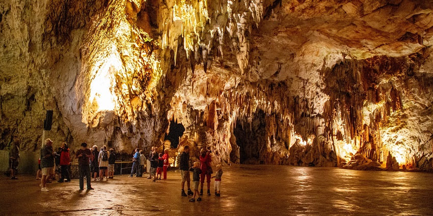 The Concert Hall in Postojna Cave glowing beautifully under magical lights in Slovenia