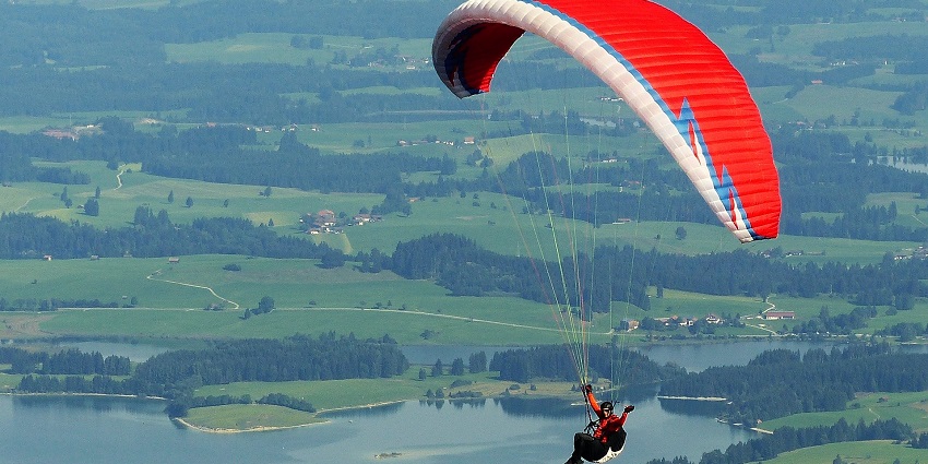 View of a paraglider soaring above Colva Beach, one of the adventure sports in Goa
