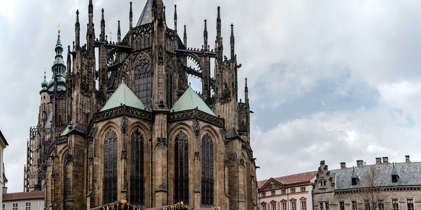 Prague Castle overlooks the Vltava River, standing tall with its historic beauty