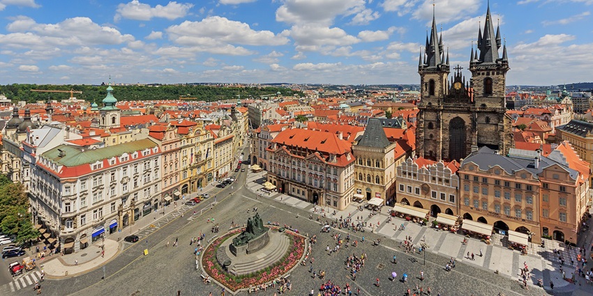 A fairy-tale city with gothic spires, cobblestone streets, and a historic astronomical clock