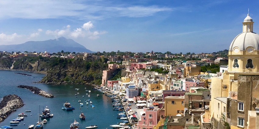 An image of boats docked on Procida Island, one of the islands in Italy for honeymoon.