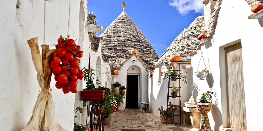 Visit Puglia’s charming trulli houses, white-washed villages, and sun-soaked olive groves.