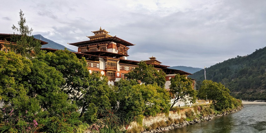 An image of the Punakha Dzong, a traditional Bhutanese building adorned with intricate carvings, colourful paintings, and cultural details.