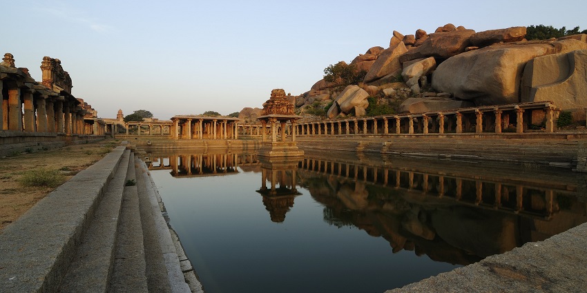 The sacred Krishna Pushkarini tank in Hampi is surrounded by ancient stone steps.