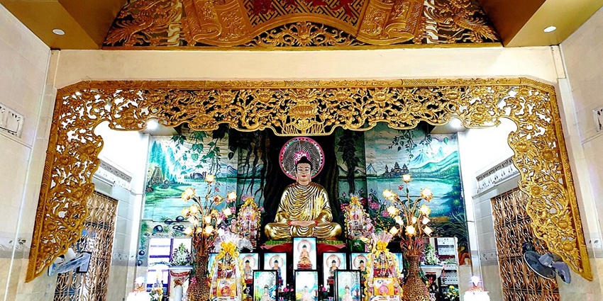 Quang Minh Temple with Buddha statue, multiple portraits and unique interior design.
