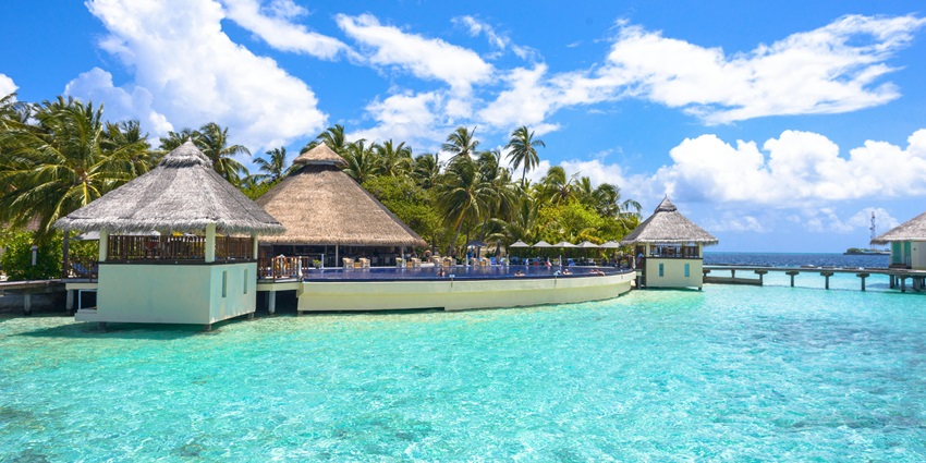 Image of Resort With Cottages surrounded by body of water- find the best veg food in Maldives