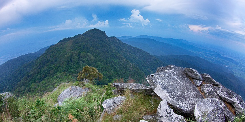 Scenic mountain view at Ramkhamhaeng National Park with lush greenery and clear blue skies.