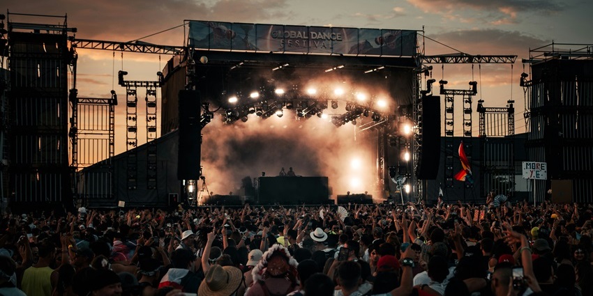 View of the vibrant Reading & Leeds Festival, with people dancing at dusk