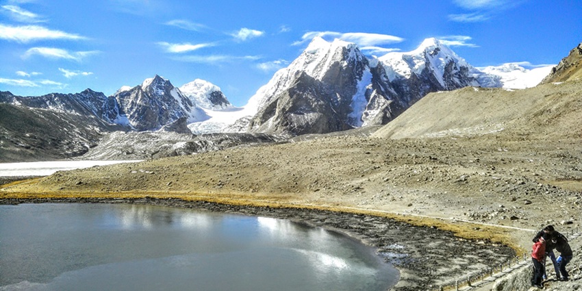 A tour organization taking walks amidst snow-blanketed paths main to Gurudongmar Lake in December.