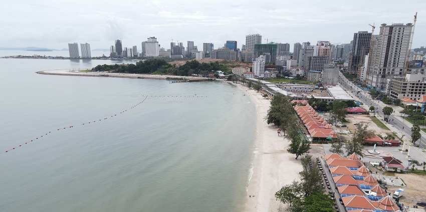 An image showing Ochheuteal Beach with sandy shores and people enjoying the coastal area.