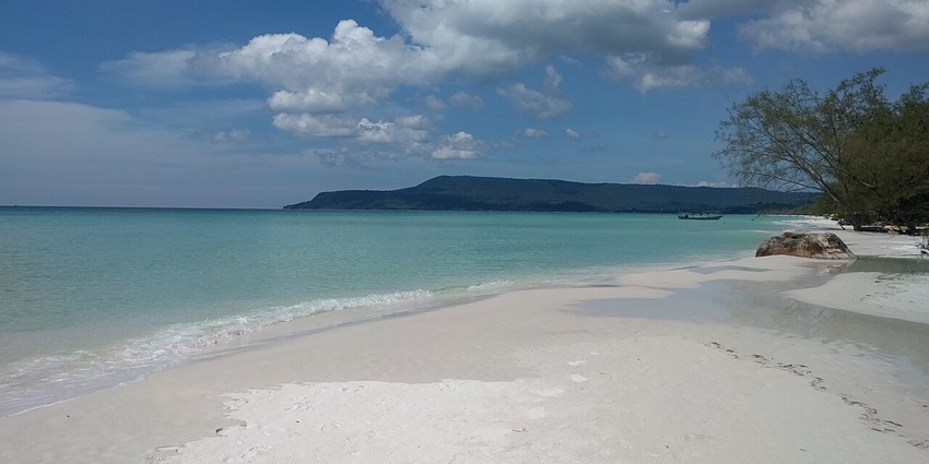 An image of The Long Beach on Koh Rong, Cambodia with clear water and calm waves.